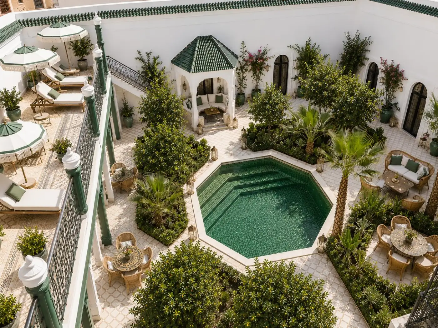 Main riad courtyard with octagonal pool, palms and sun loungers
